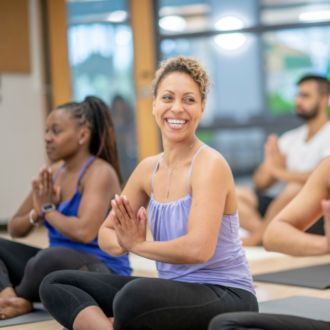 Participants at a yoga class in the seated position