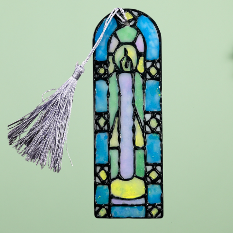 A photo of a homemade mock stained glass bookmark on a green background