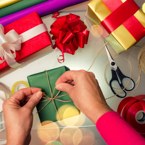 Photo of hands wrapping presents