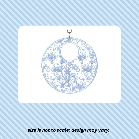 photo of acrylic pendant over white rectangle over a blue striped background