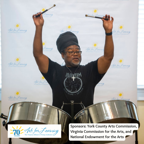 Picture of Gary "Ju Ju" Garlic raising his steel drum mallets above the drums