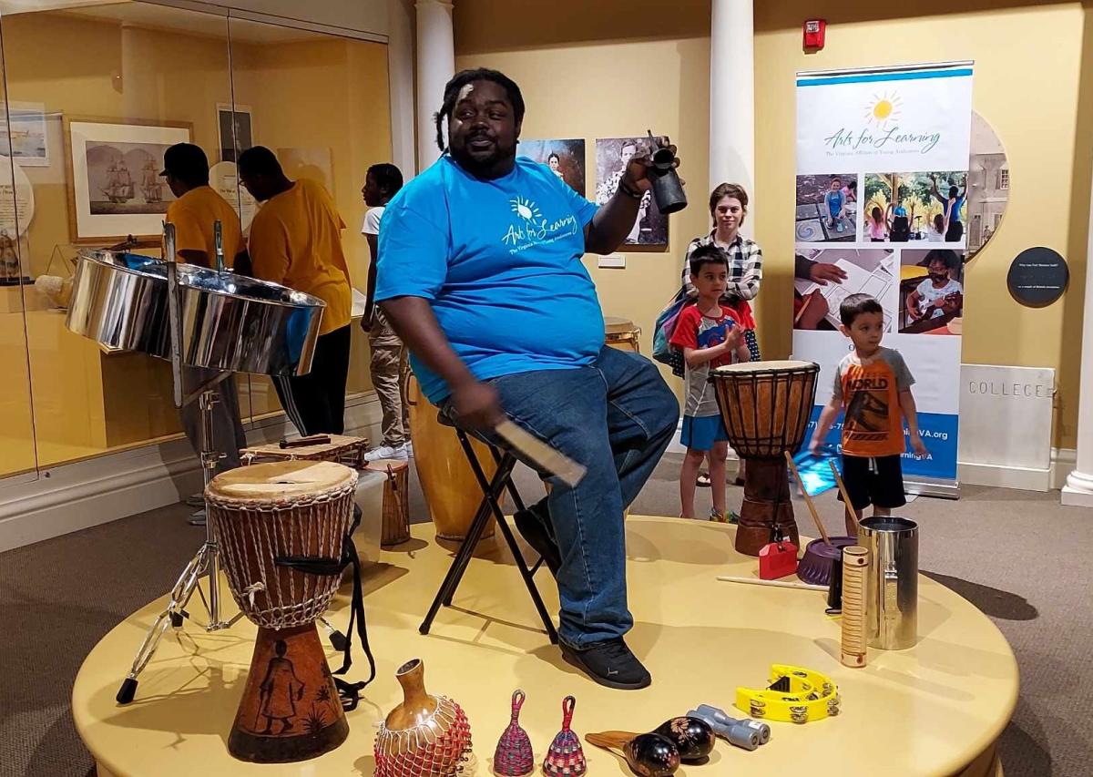 Photo of Lawrence Sawyer with an array of traditional drums.